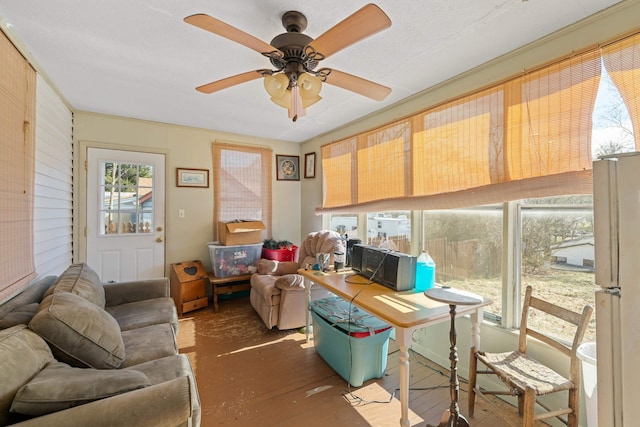 interior space with ceiling fan