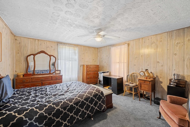 carpeted bedroom with a textured ceiling and wooden walls