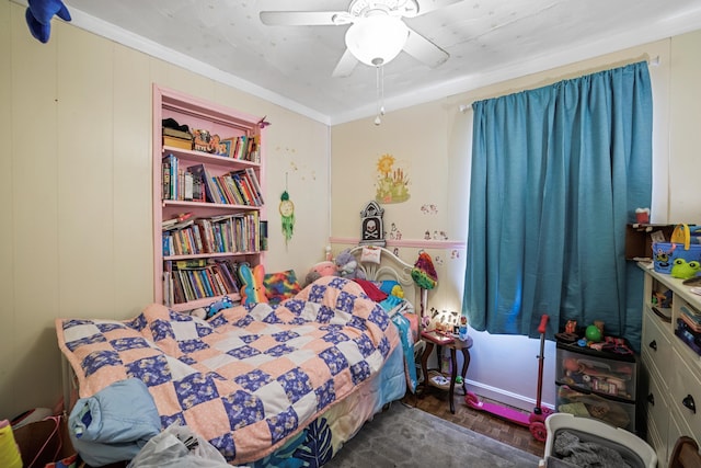 bedroom with crown molding, dark parquet flooring, and ceiling fan