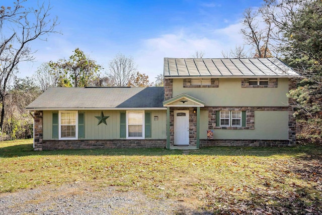 view of front of property featuring a garage and a front lawn