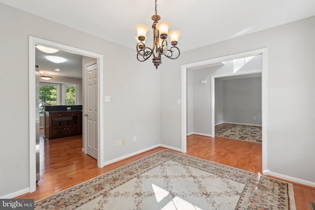 dining room featuring hardwood / wood-style floors and a chandelier