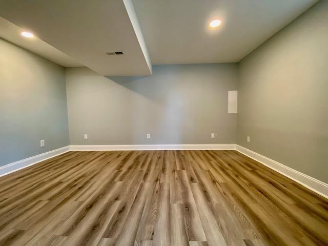 basement with light hardwood / wood-style floors