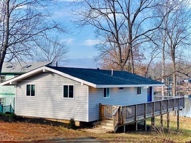 rear view of property with a wooden deck