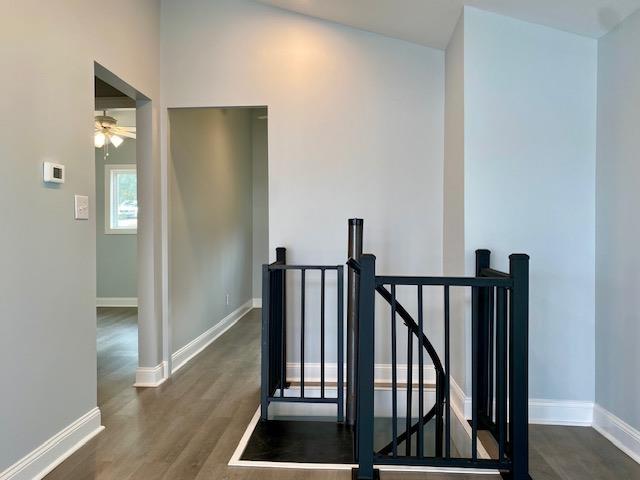 stairs with dark wood-type flooring