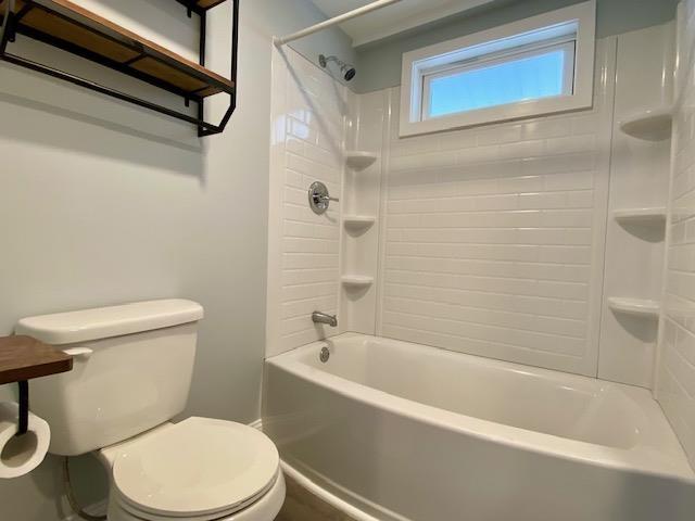 bathroom with shower / bath combination and toilet