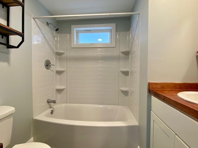 full bathroom with shower / washtub combination, vanity, and toilet