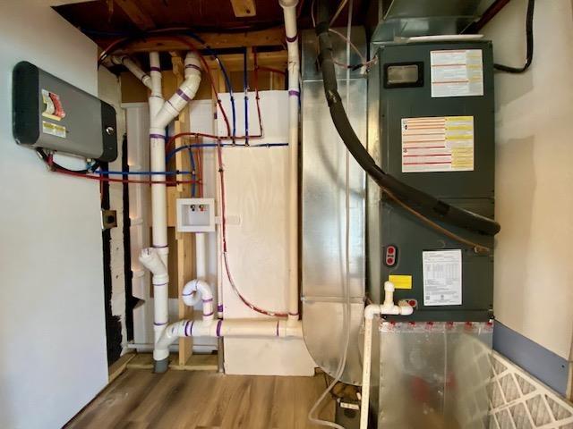 utility room featuring heating unit