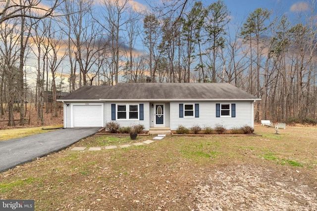 ranch-style home with a garage and a yard