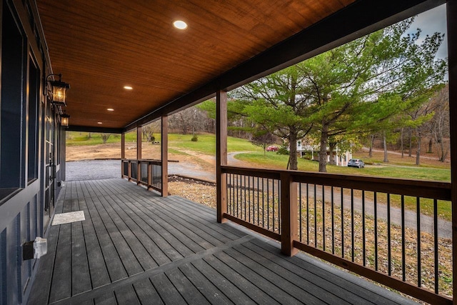 wooden terrace with a yard