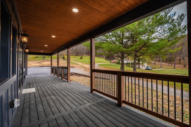 wooden terrace with a yard