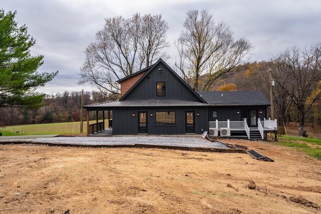 rear view of house with covered porch