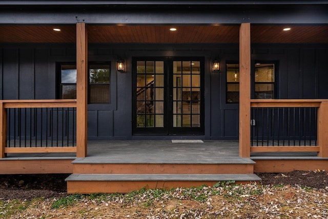 property entrance featuring french doors and a porch