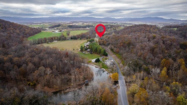 bird's eye view with a water and mountain view