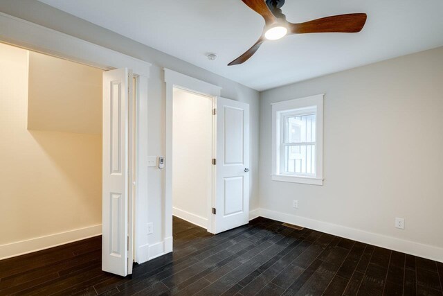 unfurnished bedroom featuring ceiling fan and dark hardwood / wood-style floors