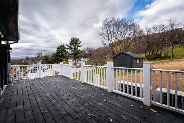 wooden deck featuring a storage shed