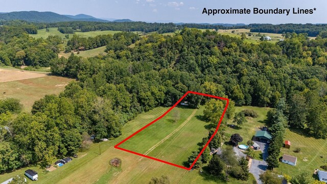 birds eye view of property featuring a mountain view and a rural view