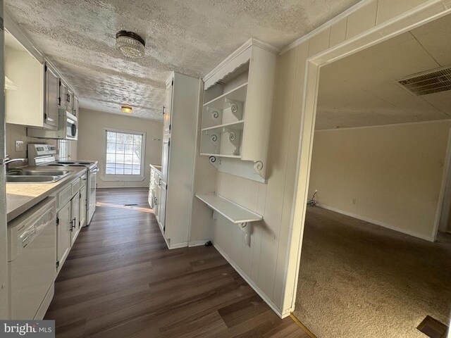 kitchen featuring white cabinetry, white appliances, dark hardwood / wood-style floors, and sink