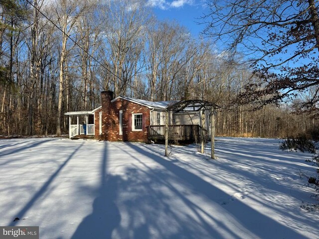 snow covered property featuring a wooden deck