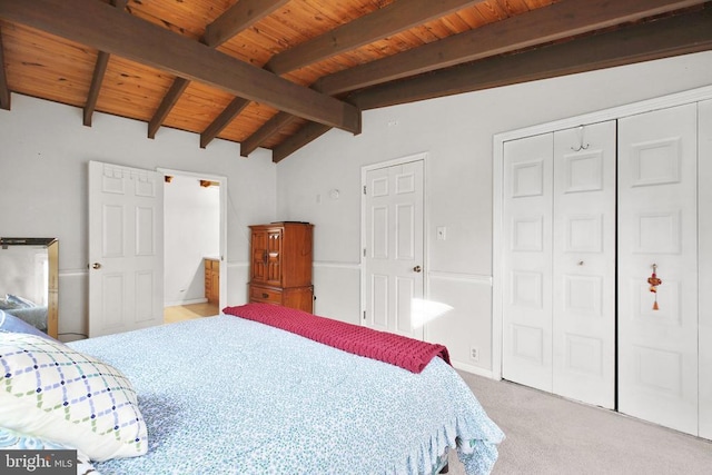 carpeted bedroom with lofted ceiling with beams, a closet, and wooden ceiling