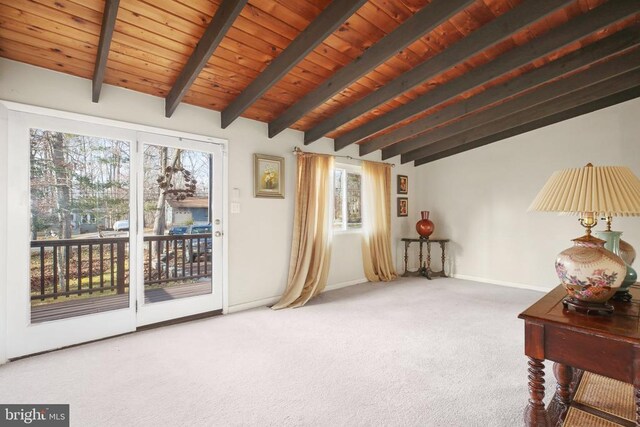 interior space featuring lofted ceiling with beams, wood ceiling, and carpet floors