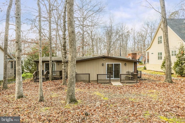 rear view of house with a wooden deck