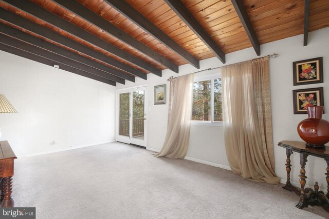 unfurnished room with lofted ceiling with beams, carpet floors, and wooden ceiling