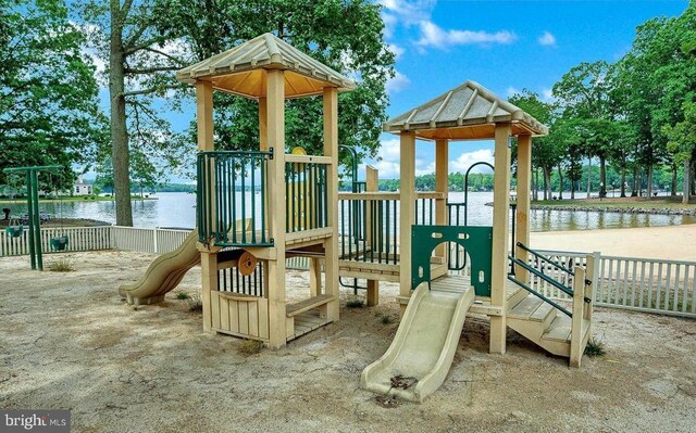 view of playground with a water view