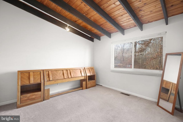 unfurnished bedroom featuring vaulted ceiling with beams, light carpet, and wood ceiling