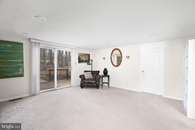 living area featuring light colored carpet