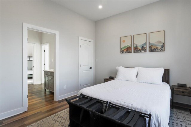 bedroom with dark hardwood / wood-style floors