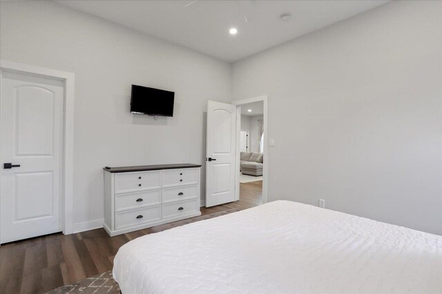 bedroom with dark hardwood / wood-style flooring