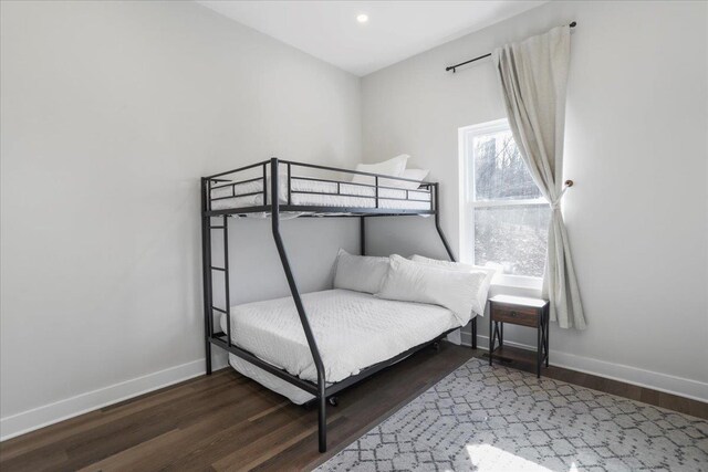 bedroom with dark hardwood / wood-style floors