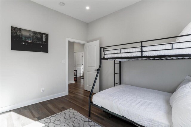 bedroom with dark wood-type flooring