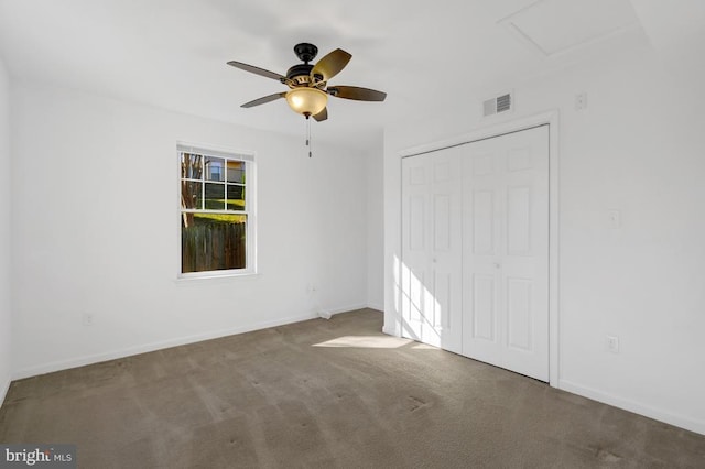 unfurnished bedroom with baseboards, visible vents, ceiling fan, a closet, and carpet flooring