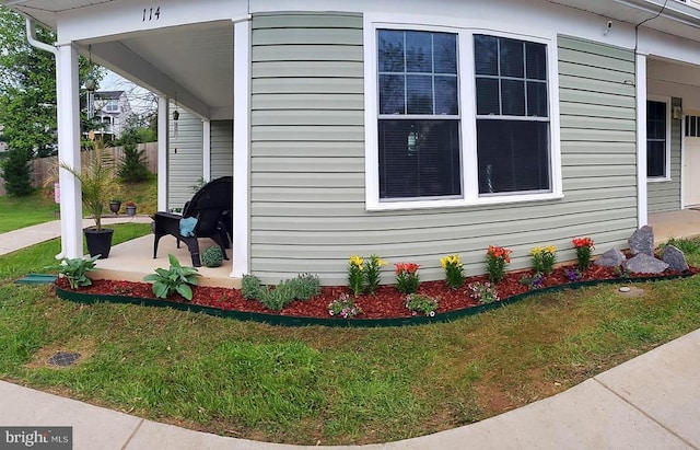 view of side of property with a lawn