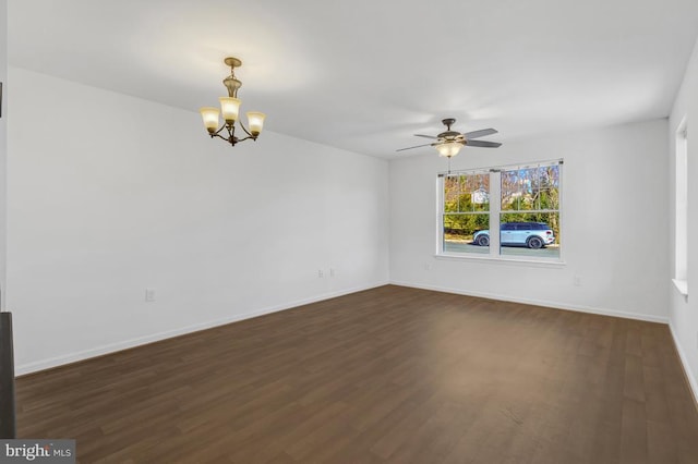 unfurnished room featuring baseboards, dark wood-style floors, and ceiling fan with notable chandelier