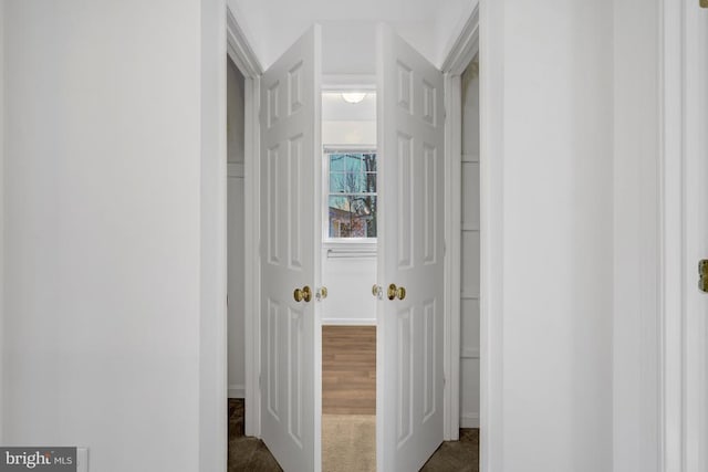 hallway featuring dark carpet