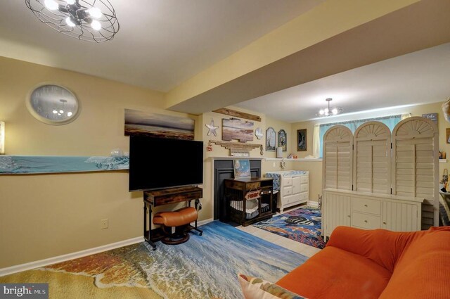 interior space featuring baseboards and a chandelier