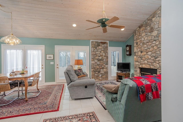 tiled living room with ceiling fan, lofted ceiling, and wooden ceiling