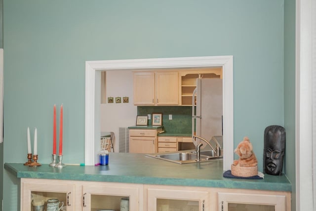 bar featuring sink, light brown cabinets, and white fridge