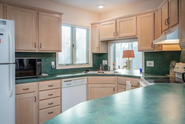 kitchen featuring white appliances, light brown cabinetry, sink, and backsplash