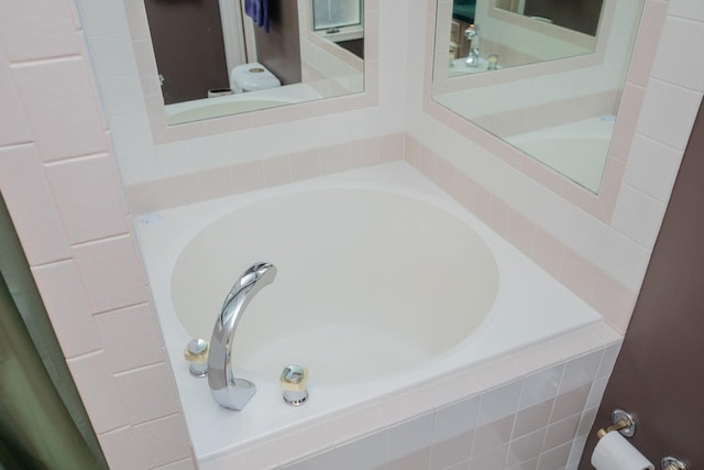 bathroom with a relaxing tiled tub