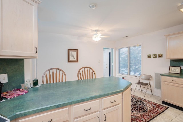 kitchen with light tile patterned floors and ceiling fan