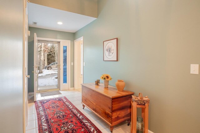 foyer entrance featuring baseboards, visible vents, and light tile patterned flooring