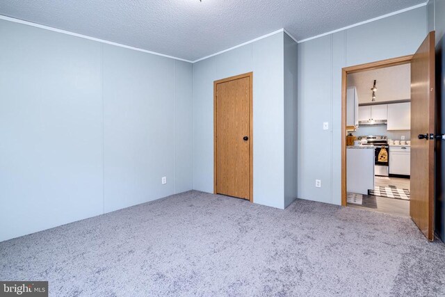 unfurnished bedroom with light colored carpet, ornamental molding, and a textured ceiling