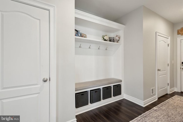 mudroom with baseboards, dark wood finished floors, and visible vents