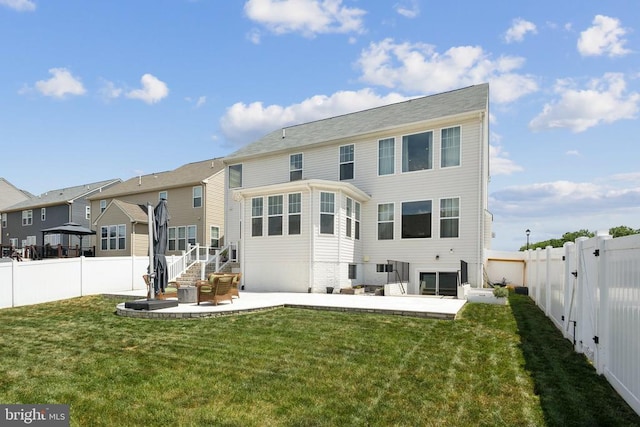 back of house featuring a fenced backyard, a patio, a yard, and a residential view