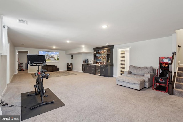 exercise room featuring baseboards, a bar, visible vents, and carpet floors