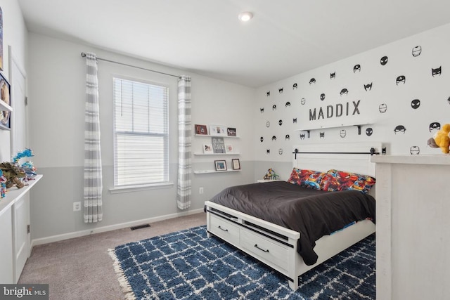 carpeted bedroom featuring baseboards, multiple windows, and visible vents
