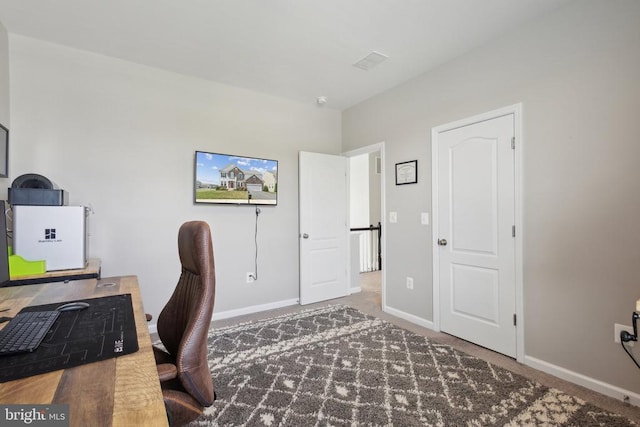 office space with baseboards and carpet flooring